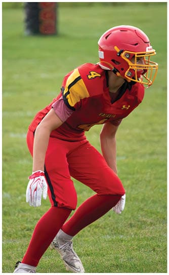 A football player catching a ball. Description generated by AI