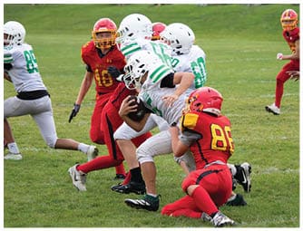 A group of football players on a field. Description generated by AI