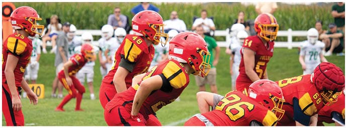 A football player wearing a blue and white uniform. Description generated by AI