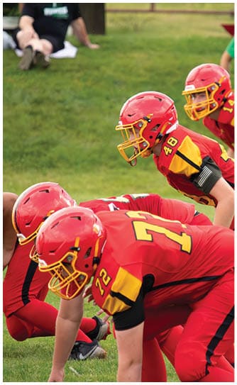 A football player catching a ball. Description generated by AI