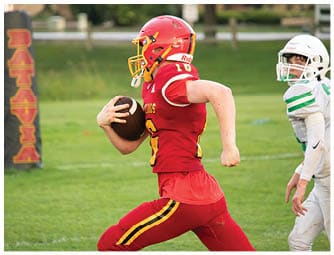 A group of football players on a field. Description generated by AI
