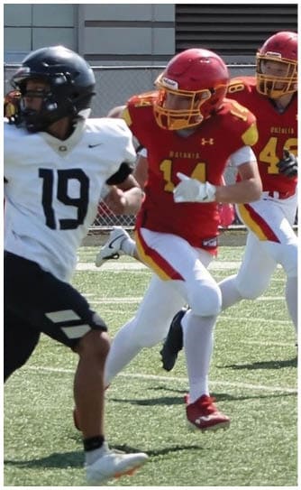 A football player catching a ball. Description generated by AI