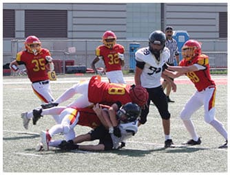 A group of football players on a field. Description generated by AI