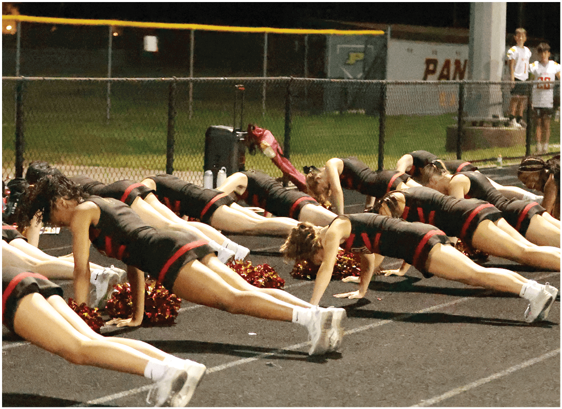 A group of football players on a field. Description generated by AI