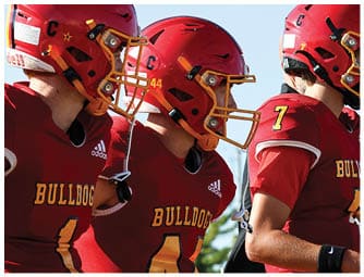 A group of football players on a field. Description generated by AI