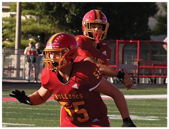 A group of football players on a field. Description generated by AI
