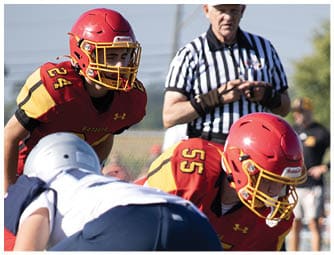 A group of football players on a field. Description generated by AI