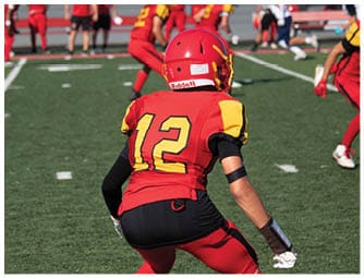 A group of football players on a field. Description generated by AI