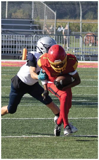 A football player catching a ball. Description generated by AI