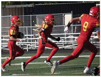 A group of football players on a field. Description generated by AI