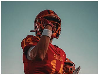 A football player running on the field. Description generated by AI