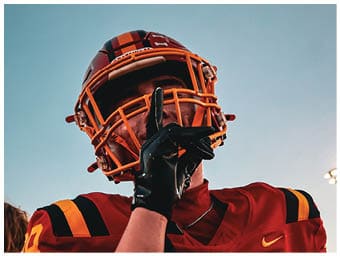 A football player running on the field. Description generated by AI