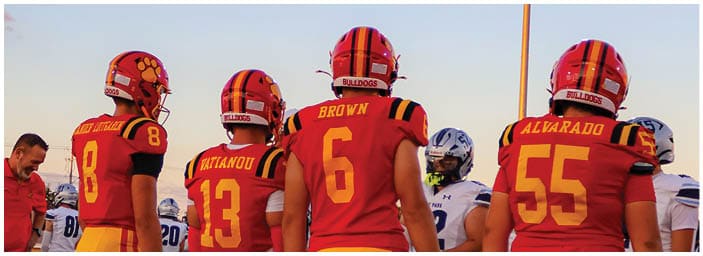A group of football players on a field. Description generated by AI