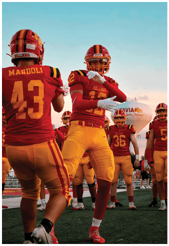 A group of football players celebrating a touchdown. Description generated by AI