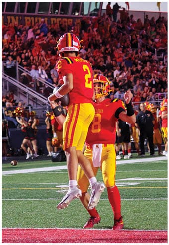 A group of football players celebrating a touchdown. Description generated by AI