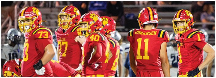 A group of football players on a field. Description generated by AI