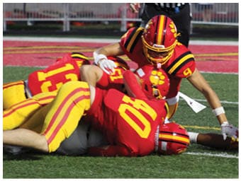 A football player running on the field. Description generated by AI