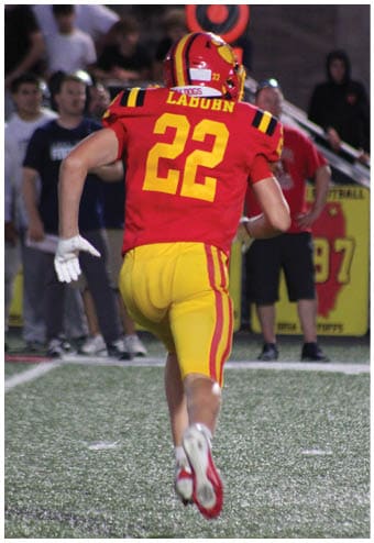 A group of football players celebrating a touchdown. Description generated by AI
