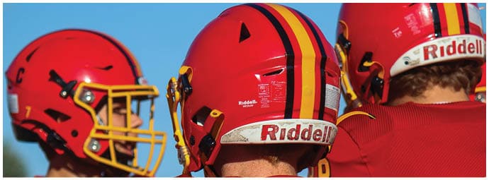 A football player wearing a blue and white uniform. Description generated by AI