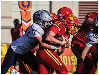 A group of football players on a field. Description generated by AI