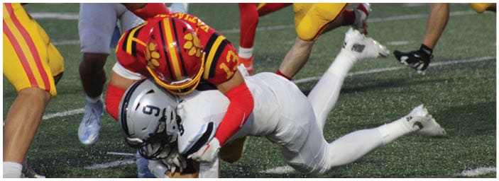 A group of football players on a field. Description generated by AI