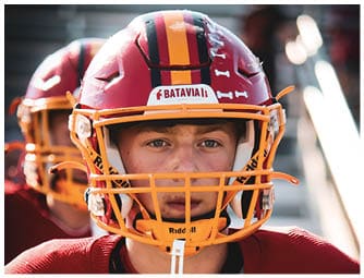 A group of football players on a field. Description generated by AI