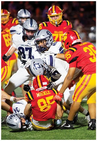 A group of football players celebrating a touchdown. Description generated by AI