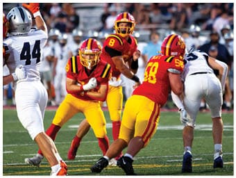 A football player running on the field. Description generated by AI