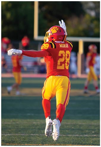 A group of football players celebrating a touchdown. Description generated by AI