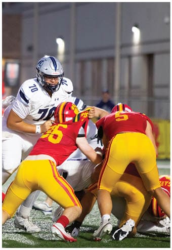 A group of football players celebrating a touchdown. Description generated by AI