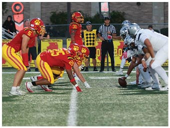 A football player running on the field. Description generated by AI