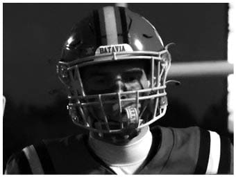A football player running on the field. Description generated by AI