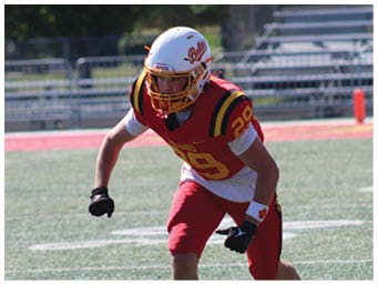 A football player running on the field. Description generated by AI
