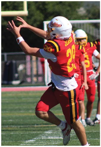 A group of football players celebrating a touchdown. Description generated by AI