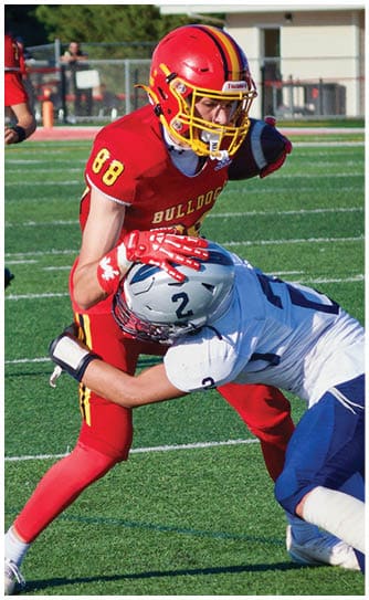 A football player catching a ball. Description generated by AI