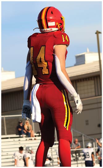A football player catching a ball. Description generated by AI