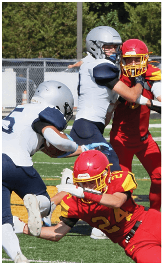 A football player catching a ball. Description generated by AI