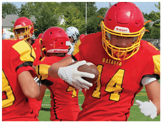 A group of football players on a field. Description generated by AI