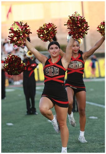 A group of football players celebrating a touchdown. Description generated by AI