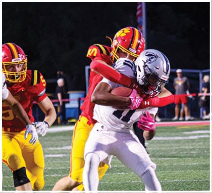 A football player running on the field. Description generated by AI