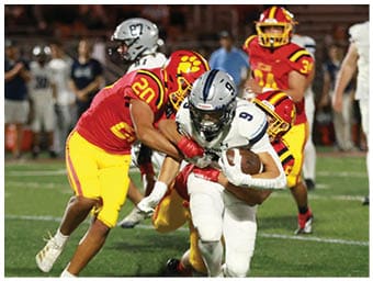 A football player running on the field. Description generated by AI