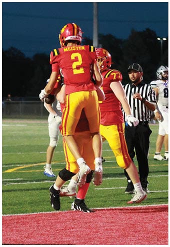 A group of football players celebrating a touchdown. Description generated by AI