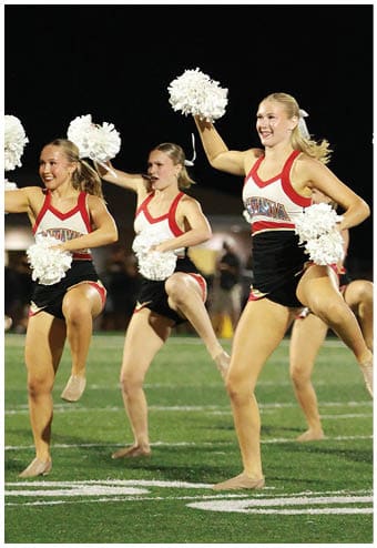 A group of football players celebrating a touchdown. Description generated by AI