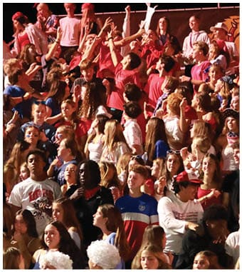 A group of football players celebrating a touchdown. Description generated by AI