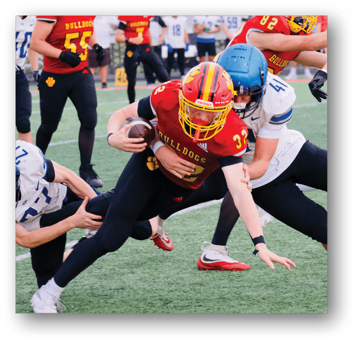 Three football players in blue and white uniforms running on a field. Description generated by AI