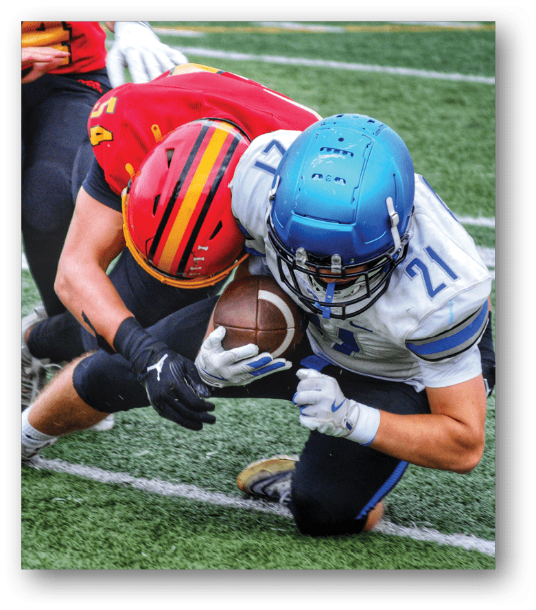 Three football players in blue and white uniforms running on a field. Description generated by AI