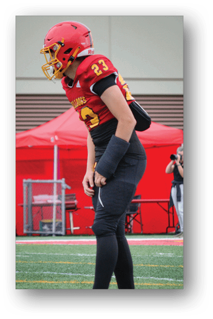 A football player catching a ball. Description generated by AI