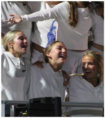 A group of football players celebrating a touchdown. Description generated by AI