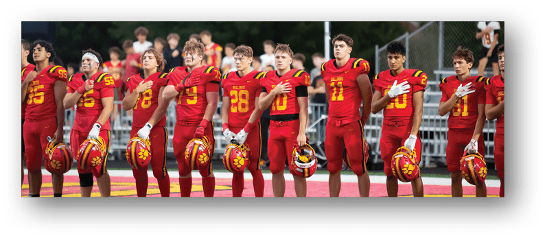 A group of football players on a field. Description generated by AI