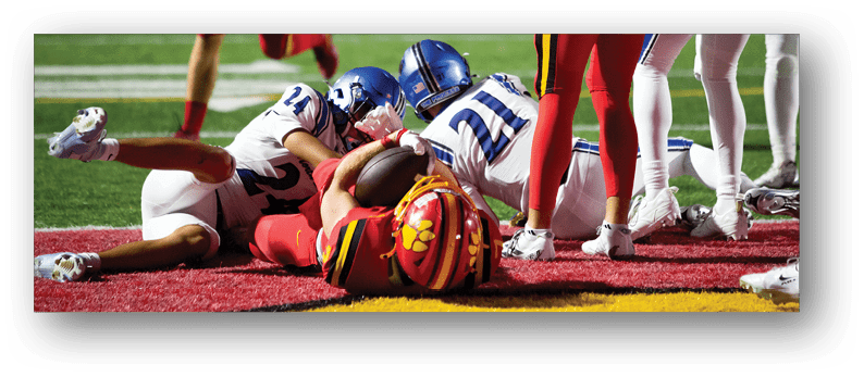 A group of football players on a field. Description generated by AI